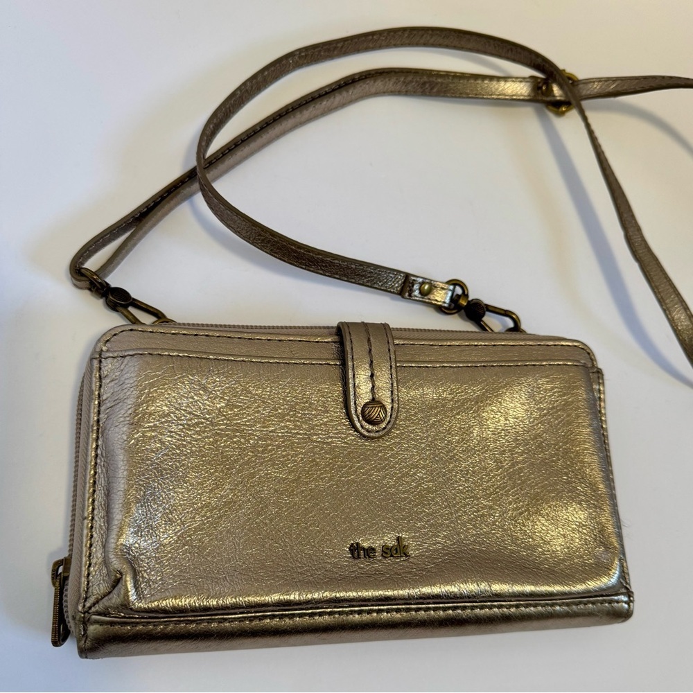 The SAK  leather smartphone convertible crossbody wallet in a metallic GOLD